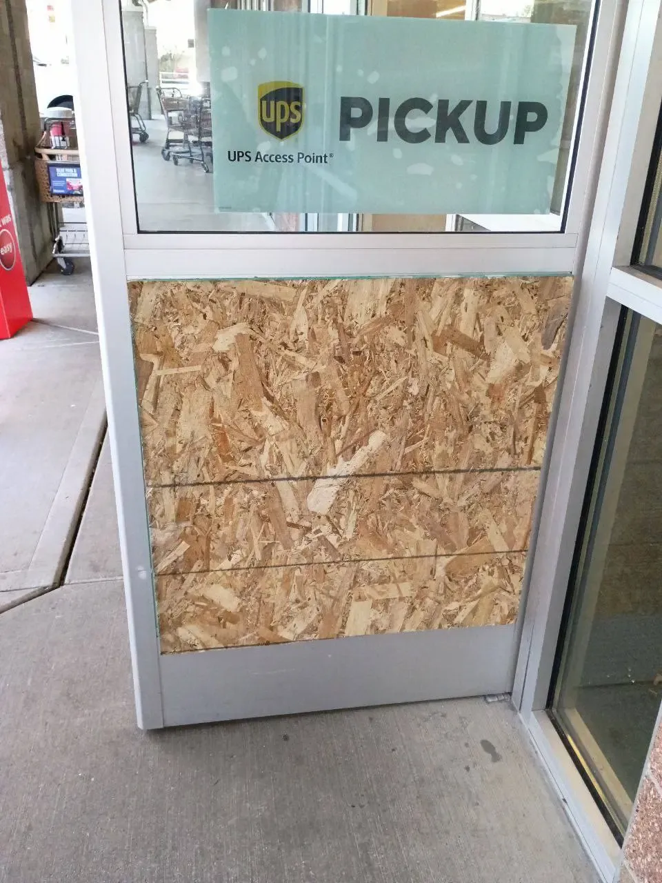 Timber boarding over the matching commercial door opening, a temporary securing stage.