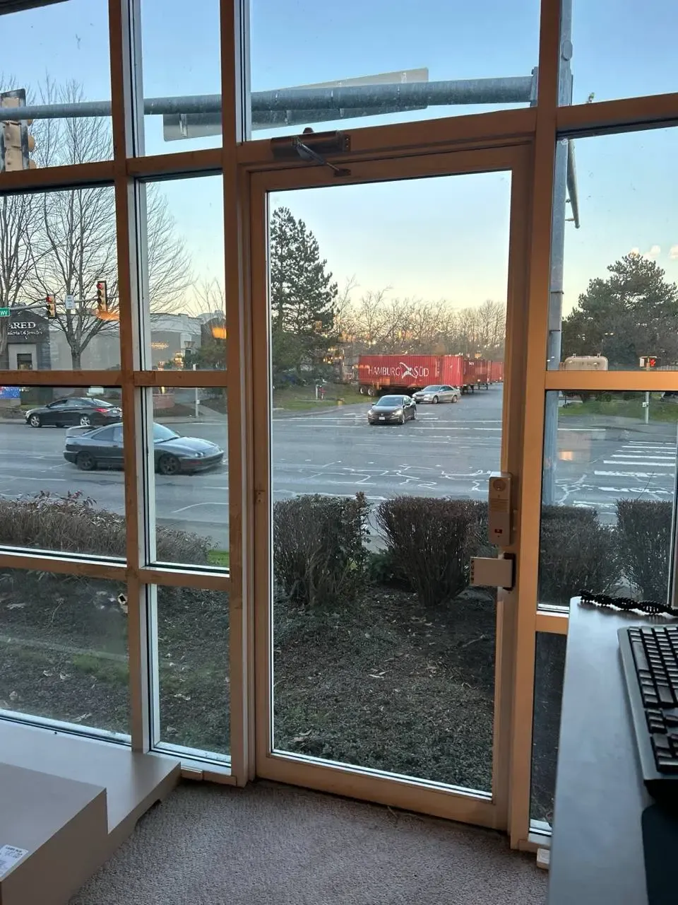Single glazed entrance with an overhead door closer and arm