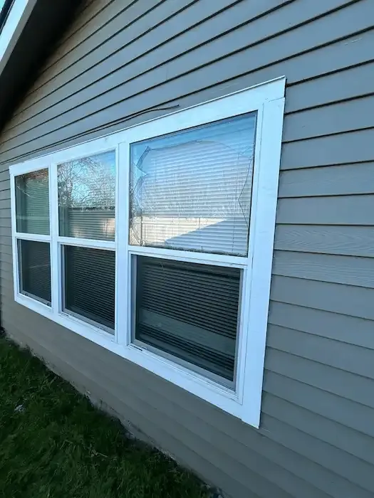 White-framed home windows with a crack across the upper right pane