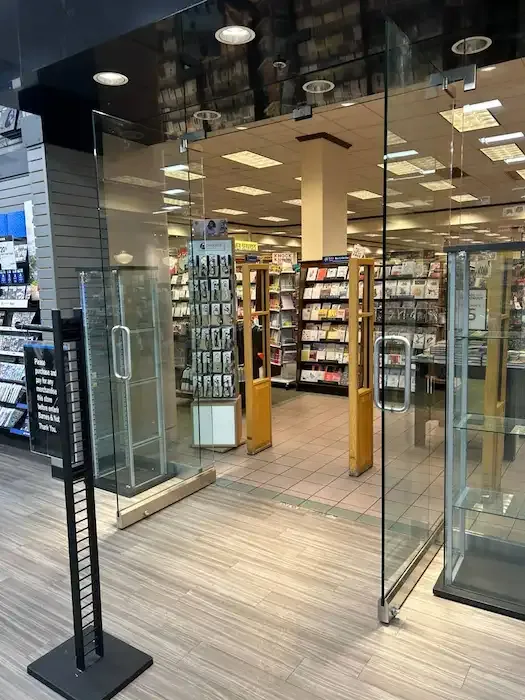 Glass storefront entrance with paired doors at a retail shop