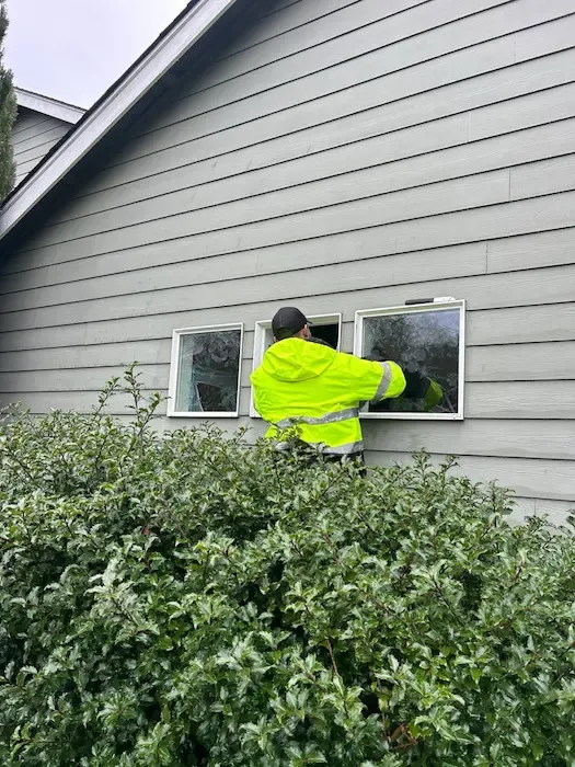 Technician installing replacement window glass