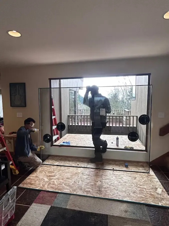 Technician installing a residential window glass pane