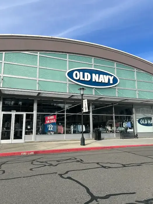 Old Navy storefront with glass entrances and a curved upper facade