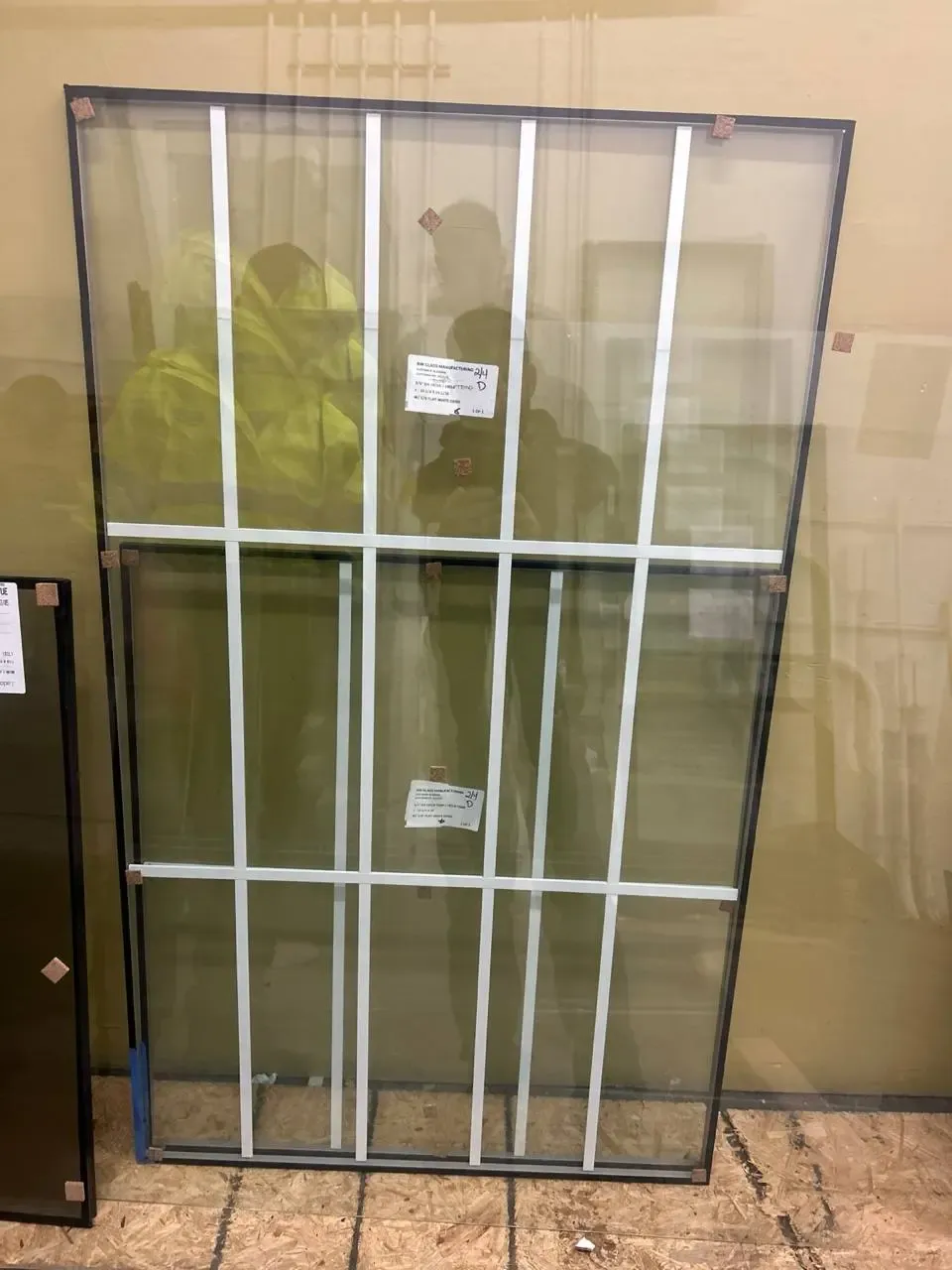 A freestanding glass unit with white grid bars, edge spacers and labels.