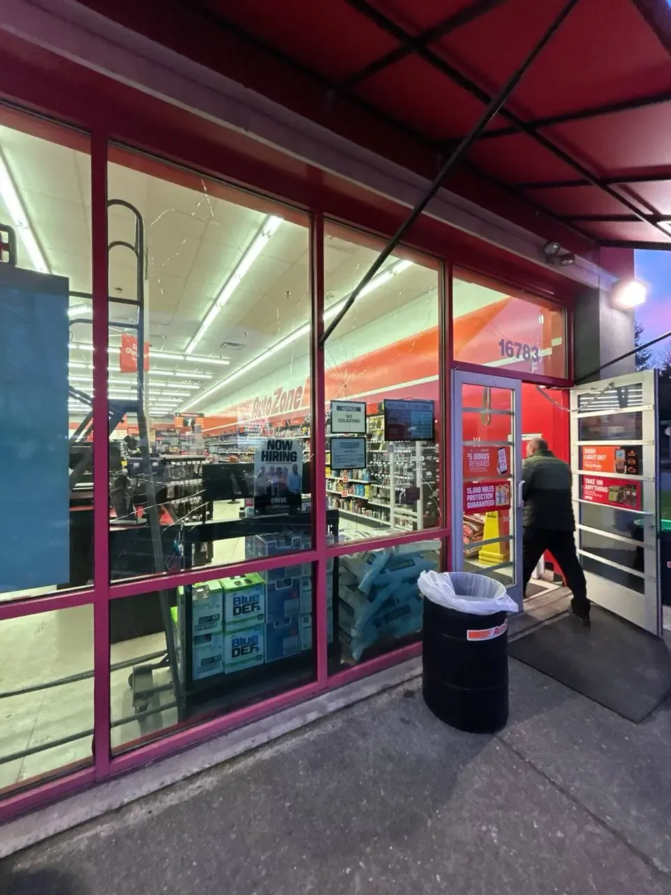 Damaged commercial display glazing beside a glass entrance