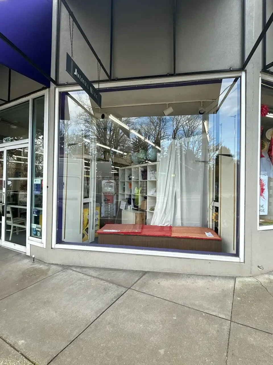 Large street-facing display window in a metal storefront frame