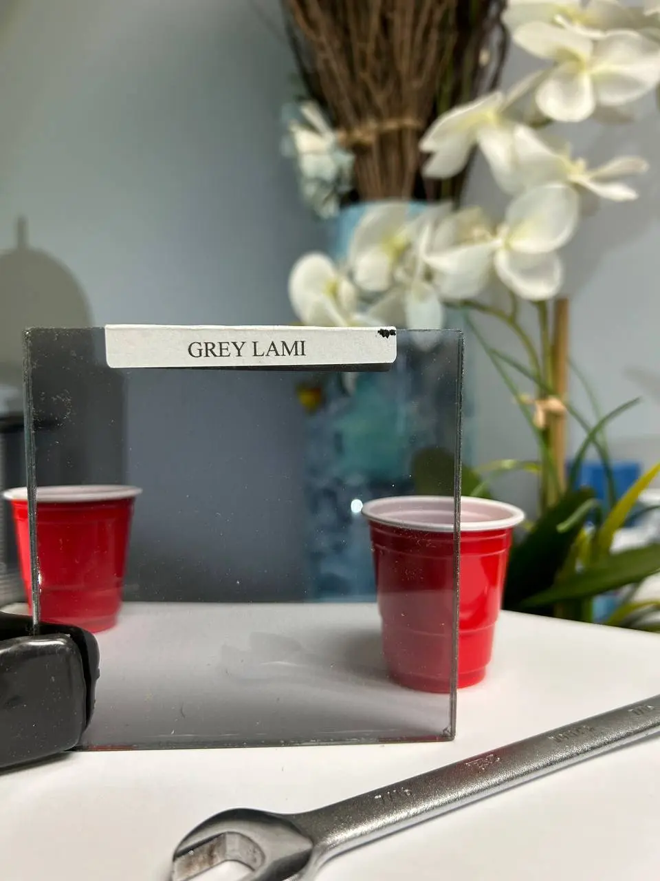 Grey laminated glass for safety, glare reduction, and a clean smoked appearance.