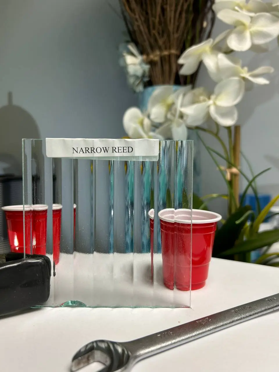 Narrow vertical reeded glass that obscures detail while adding strong linear rhythm.