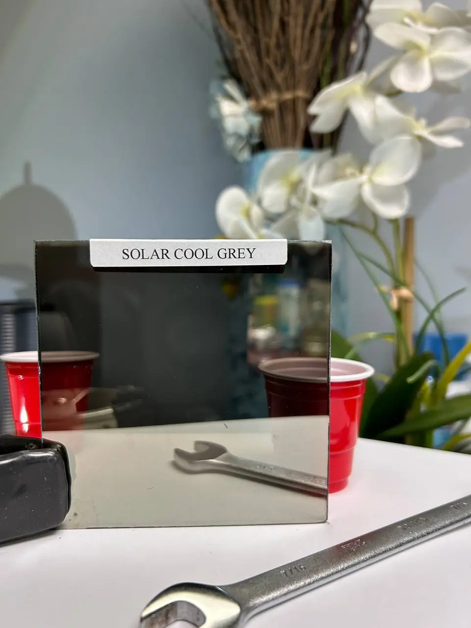 Dark grey solar-control glass for stronger light reduction and a cooler smoked look.